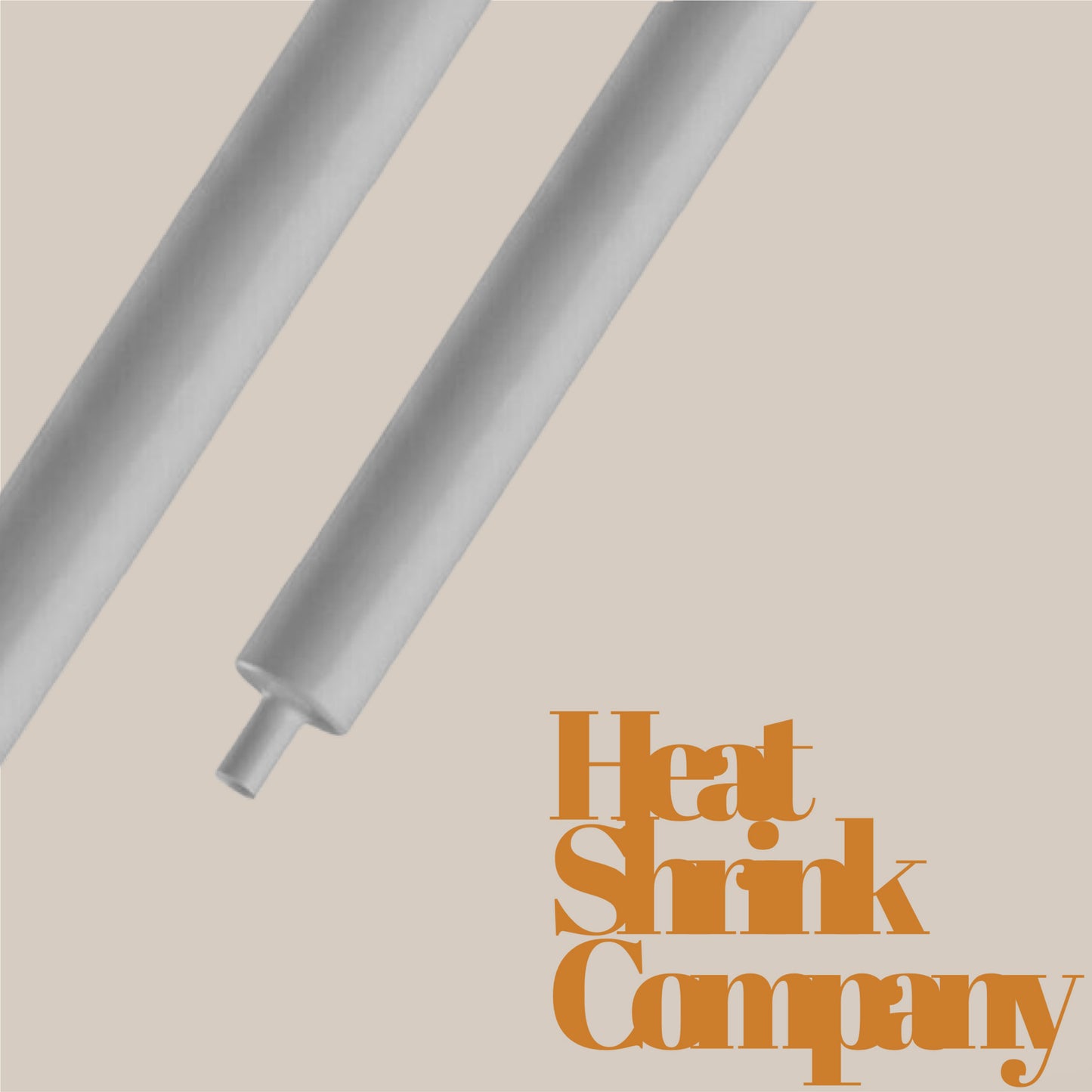 Two grey heat shrink tubes on a beige background, with text reading "Heat Shrink Company" in the lower right corner.
